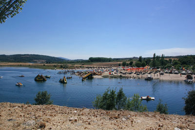 Scenic view of lake against clear blue sky