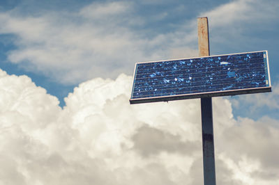 Low angle view of solar against cloudy sky