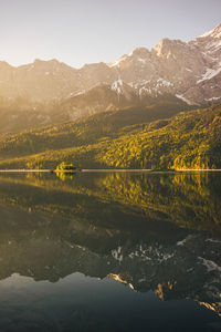 Scenic view of lake and mountains against clear sky