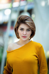 Portrait of young woman standing outdoors