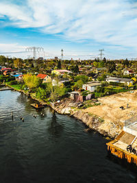 High angle view of river by buildings against sky