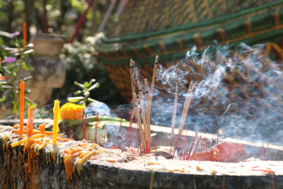 Close-up of lit candles in temple