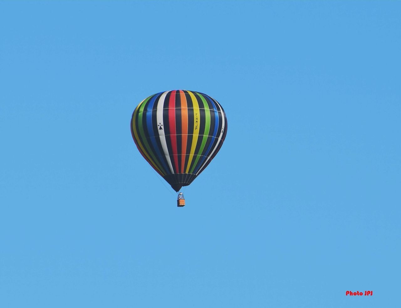 LOW ANGLE VIEW OF HOT AIR BALLOONS AGAINST BLUE SKY