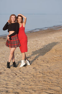 Two beautiful but different women walking on the beach. female friendship. homosexual women. 