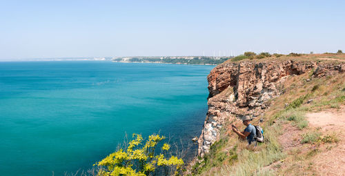 Adult man photographing the sea at kaliakra cape, bulgaria