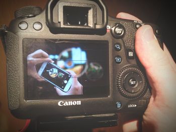 Close-up of cropped hand holding mobile phone