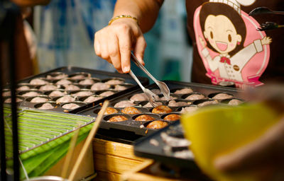 Midsection of man preparing food