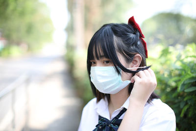 Young woman wearing mask outdoors
