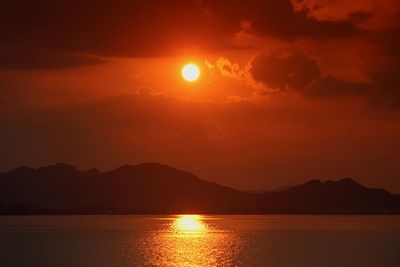 Scenic view of silhouette mountains against sky during sunset