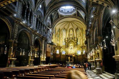 People in illuminated cathedral