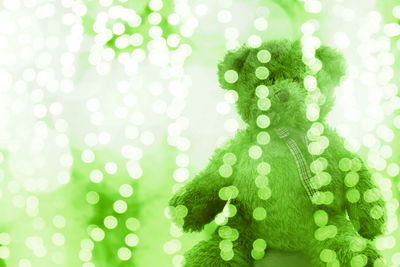 Close-up of teddy bear and illuminated lighting equipment