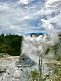 Scenic view of waterfall against sky