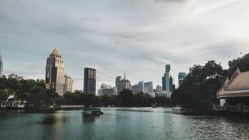 River by buildings against sky in city