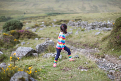 Side view of young girl on  ountryside field