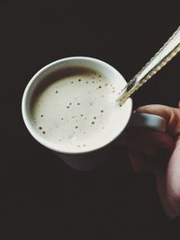 Cropped hand holding coffee cup