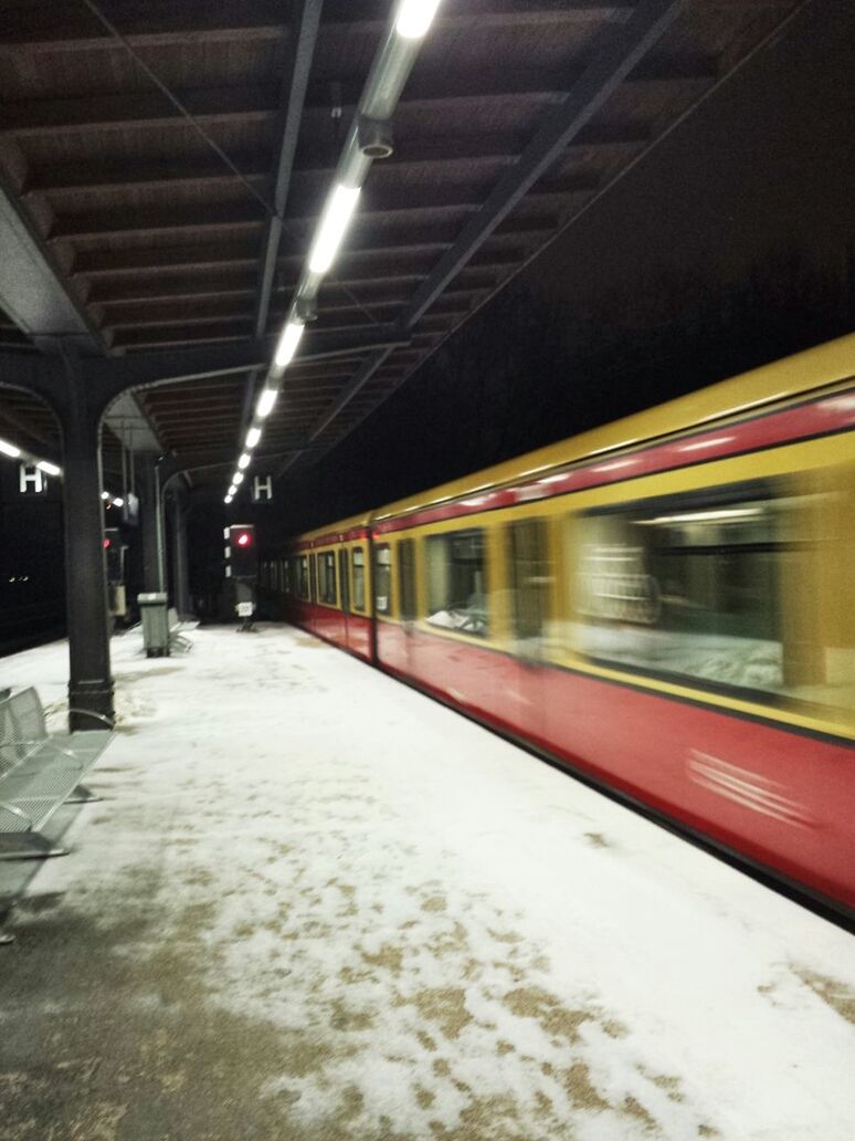 TRAIN ON RAILROAD STATION PLATFORM