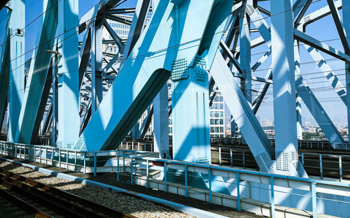 Low angle view of bridge and buildings against sky