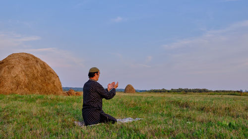 Man on field against sky