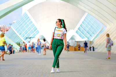 Full length portrait of woman standing outdoors