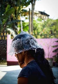 Close-up of woman with splashing water at water park