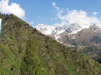 Scenic view of mountains against cloudy sky