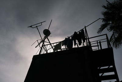 Low angle view of silhouette building against sky during sunset