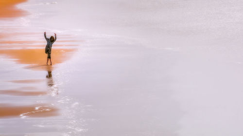 Reflection of man in sea