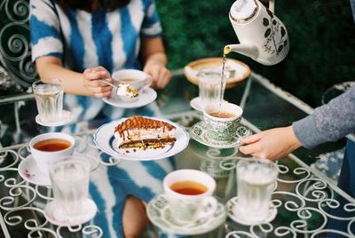 People having food and drink at table