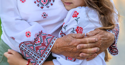 Senior woman embracing granddaughter