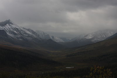 Scenic view of mountains against cloudy sky