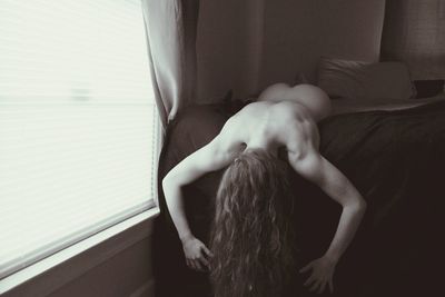 Close-up of woman standing against white wall