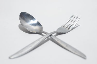 Close-up of electric lamp on table against white background