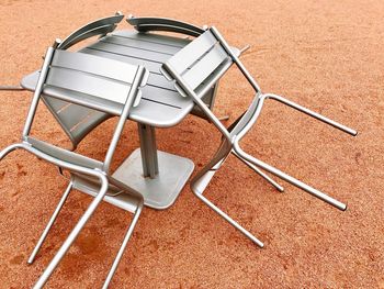 High angle view of empty chairs and table