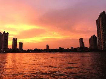 City at waterfront during sunset