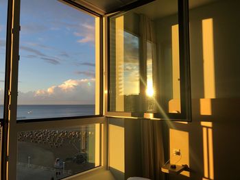 Reflection of sky on glass window at home