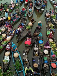 High angle view of people selling vegetables on boats in lake