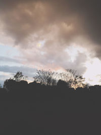 Low angle view of silhouette trees against sky at sunset