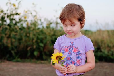 Close-up of baby girl against plants