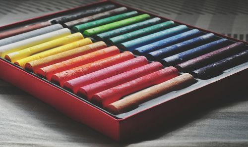 Close-up of colorful crayons on bed