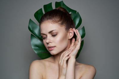 Portrait of young woman over black background