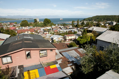 High angle view of houses in town against sky