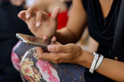 Close-up of woman holding smart phone