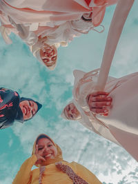 Low angle view of woman smiling