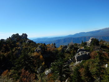 Scenic view of mountains against clear blue sky