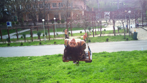 Portrait of woman playing on swing