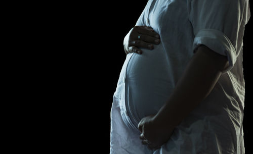 A pregnancy woman touch her stomach as she feel near labor pain.