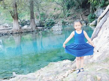 Portrait of smiling woman standing in water