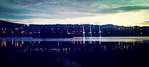 Scenic view of lake against sky at night