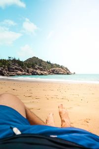 Low section of woman lying on beach
