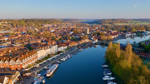 Aerial view of river amidst buildings in town